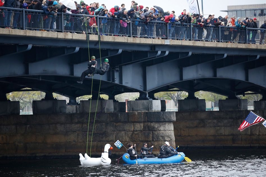 MIT students and staff members rappelled off the bridge over the Charles River, as part of the “Crossing the Charles” procession and competition.
