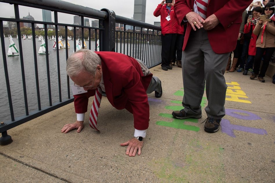 Oliver Smoot ’62, whose body length was used to measure the bridge over the Charles River near MIT, in a noted 1958 prank by MIT students, demonstrates how he did it. Smoot served as grand marshal in the “Crossing the Charles” procession and competition.
