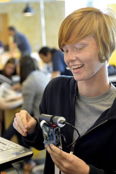 A student shows off her finished Raspberry Pi camera. 