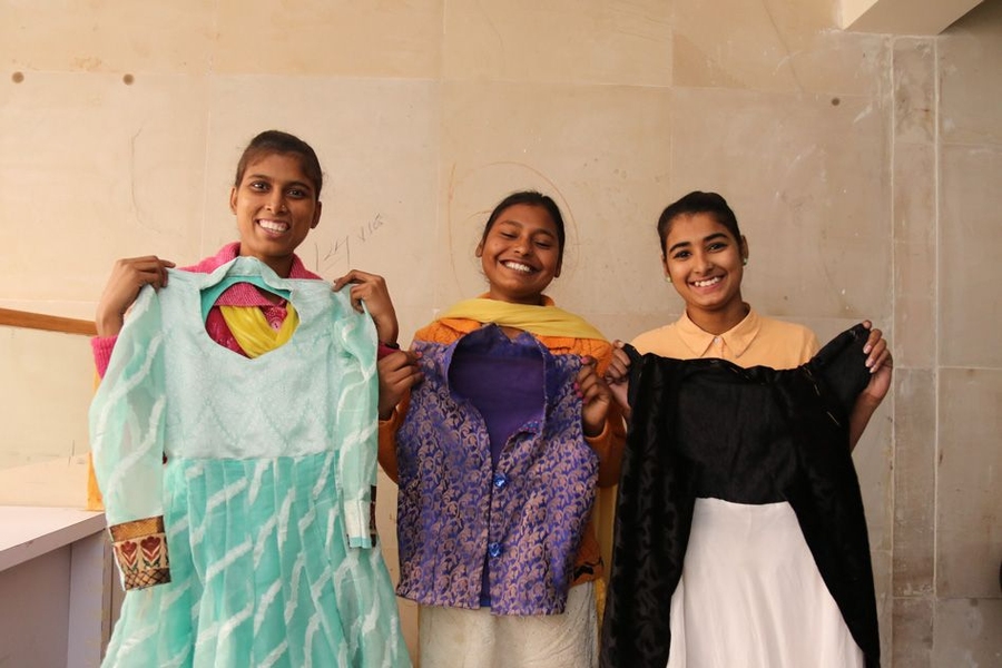 Young women show off their handiwork at a class to learn sewing skills offered by a Delhi office of India's Self Employed Women's Association (SEWA). Cardoso is working with SEWA to assess the impact of technology on the lives and work of SEWA's 1.9 million members, who make their living through their own labor or their own business. Because SEWA members are often very low-income workers, how th...