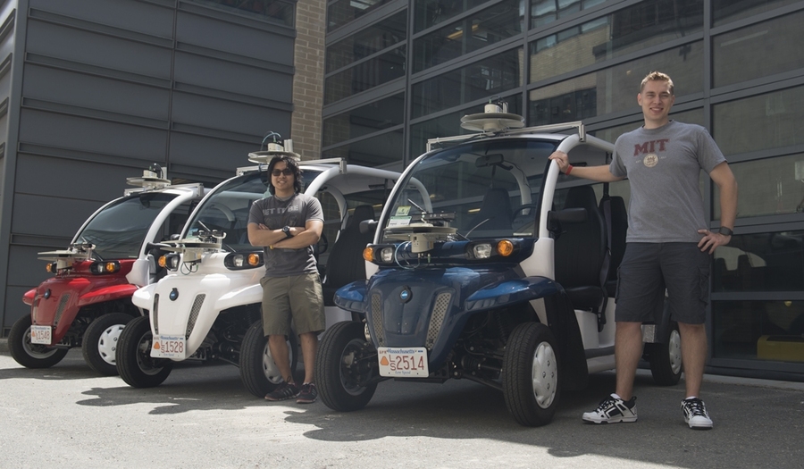 MIT junior Wally Wibowo (left) and graduate student Justin Miller with the three vehicles they have outfitted with LIDAR and cameras to capture user and traffic data while shuttling people around West Campus.