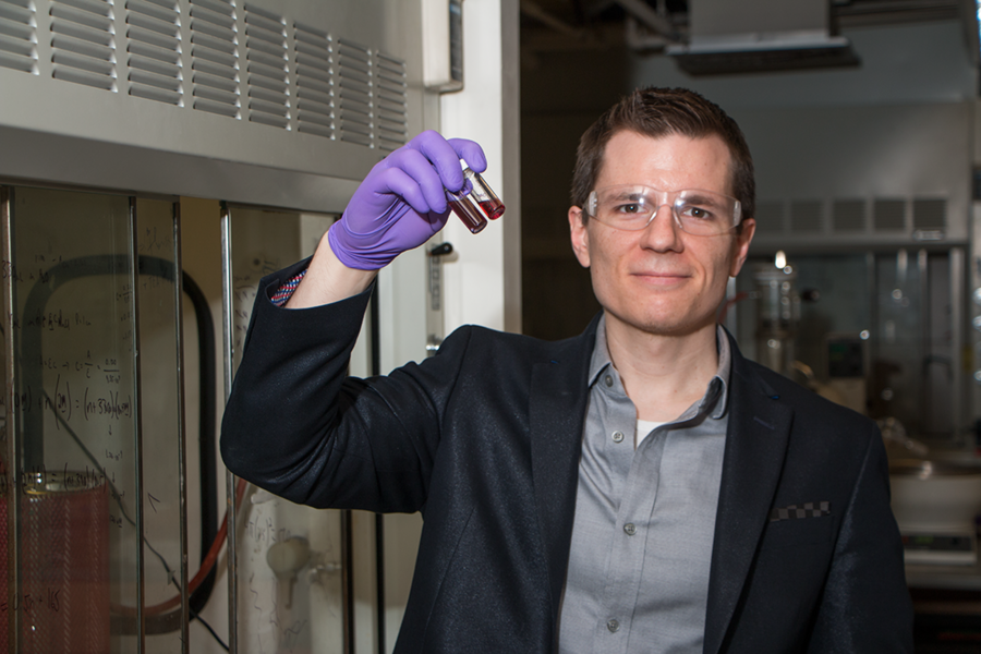 Robert Macfarlane, the AMAX Assistant Professor of Materials Science and Engineering at MIT, holds vials of gold nanoparticles. Macfarlane designs nanoscale crystal structures whose assembly is activated by mutually attractive “sticky ends.”
