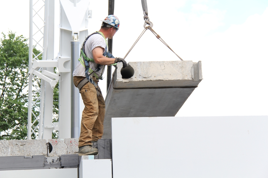 A precast concrete section is lifted into place for a net-zero home built in Edmonton, Alberta, Canada. 