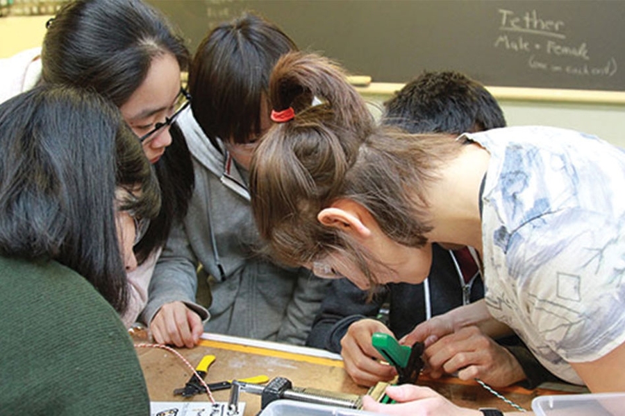 Cheetiri Smith explains to one of the 10 groups how to crimp wires. 