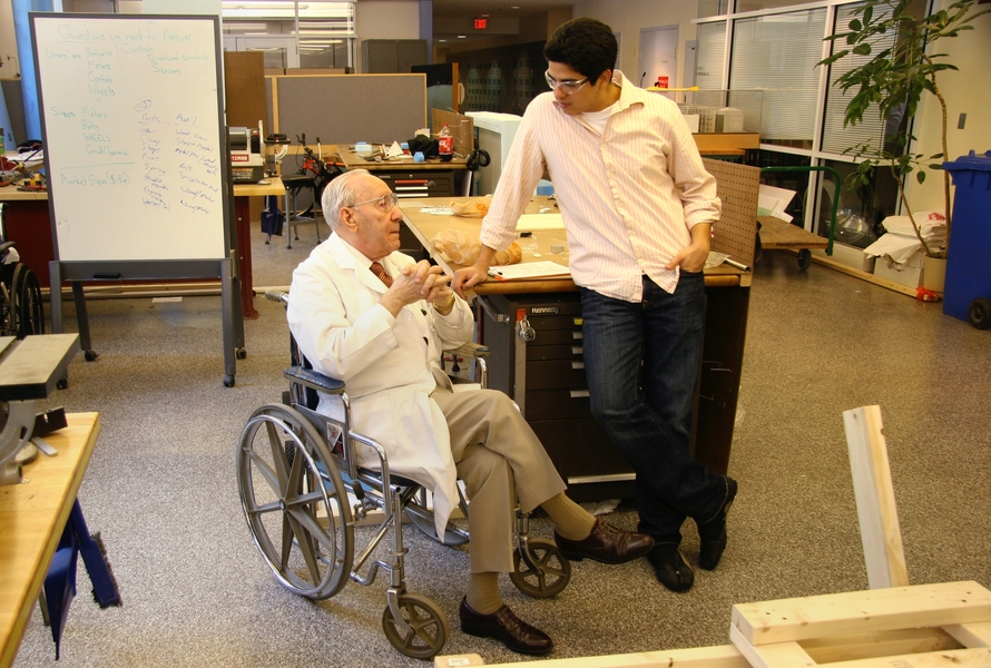 Professor Ernesto Blanco, in his signature white lab coat, meets with a student in MIT’s Pappalardo Lab.