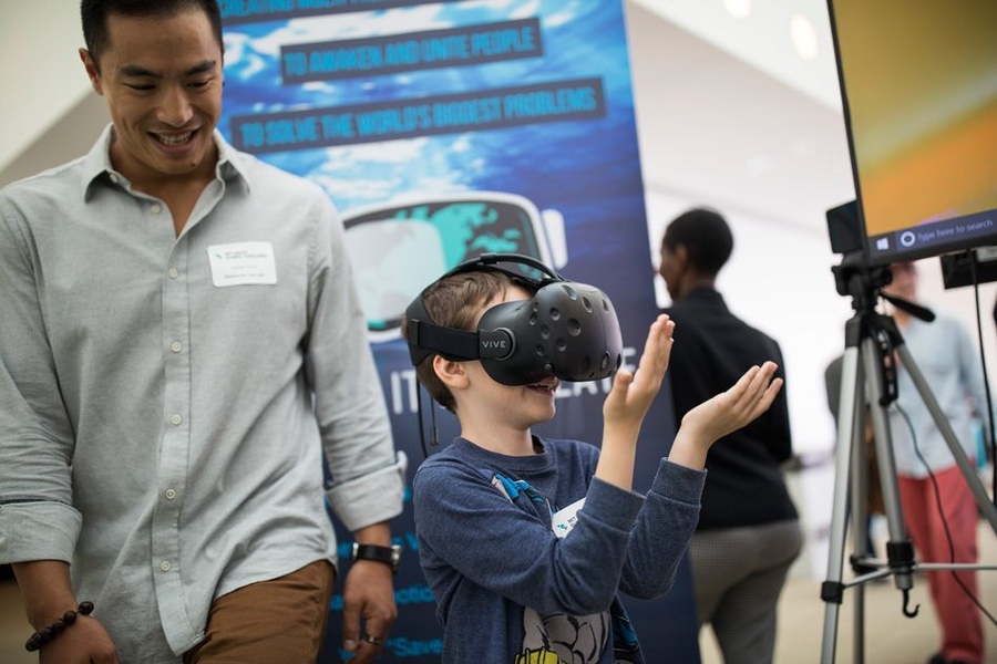 An attendee takes a virtual tour of a flooded Florida coast, with technology from Before It's Too Late, a team creating virtual-reality simulations that demonstrate the impact of climate change on the world.