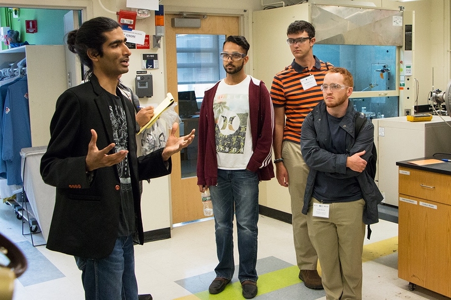 Graduate student Karthik Akkiraju explains the work in the Electrochemical Energy Lab of Yang Shao-Horn to Summer Scholars Saleem Iqbal, Ben Canty, and Luke Soule. Soule has chosen to work in the lab for the summer.