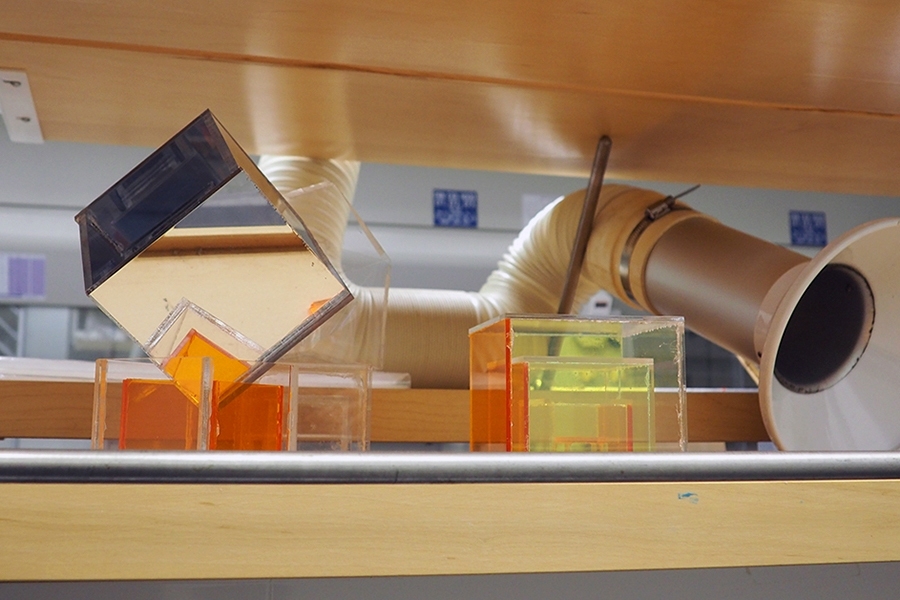 Nested cubes are assembled on a lab shelf in Buliding 18, nestled among snorkel fume hoods. The display was part of a thesis project by Angel Chen MS '17. 