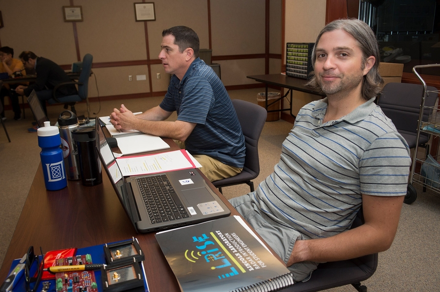 High school physics teachers Gary Campbell (left) and Scott Brunner joined students in the classroom to learn about building small radar systems.
