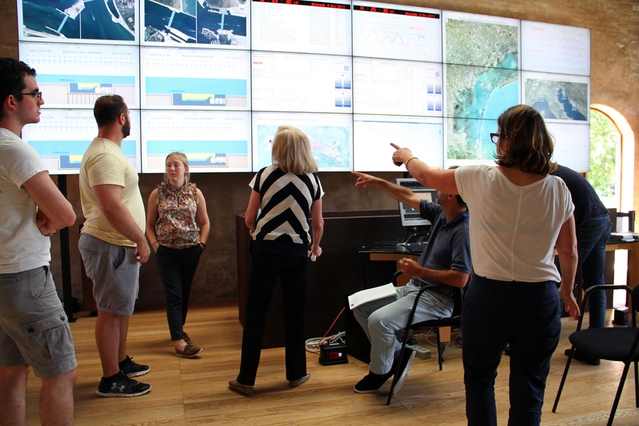 Professor Paola M. Rizolli (center) and representatives from Consorzio Venezia Nuova discuss the data behind Venice's experimental floodgates project after MIT students René Andrés García Franceschini, Matthew Robayna, and Julia Pallone presented their statistical data analysis.