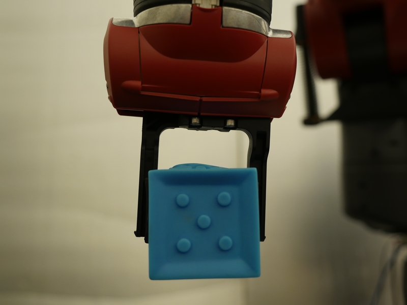The Baxter robot picks up a block using the ComText system.
