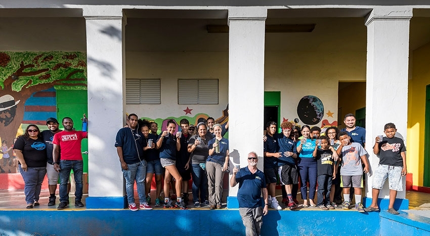 Local children join the team in raising their glasses of clean water after the tap-opening ceremony in late October. 