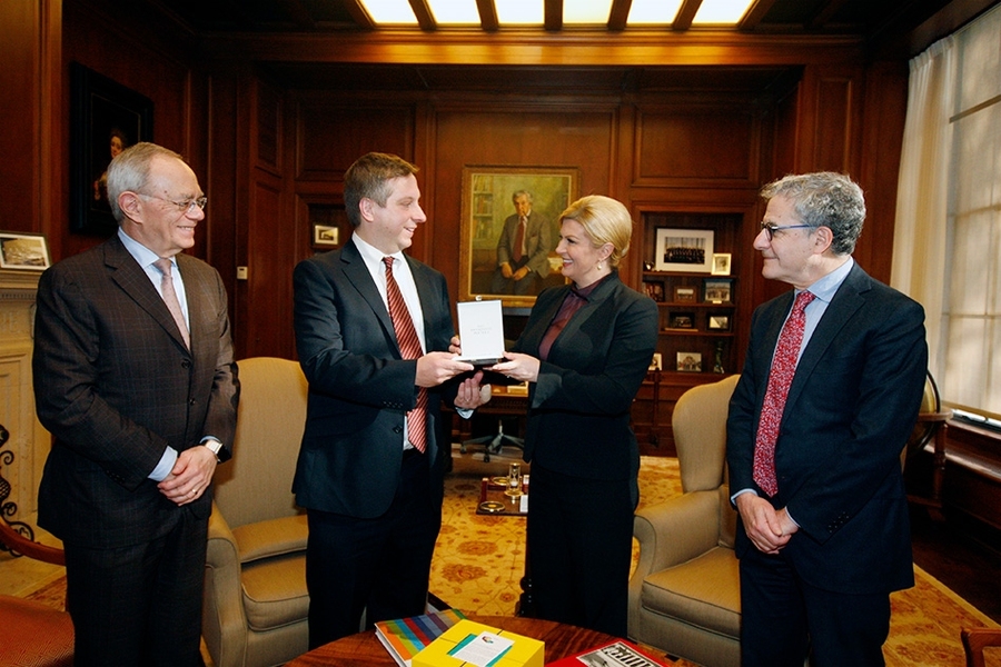The president of Croatia, Kolinda Grabar-Kitarović, visited MIT on Monday, Dec. 4. From left: MIT President L. Rafael Reif; MIT physicist Marin Soljačić, receiving an award the Croatian president, Kolinda Grabar-Kitarović; and the Dean of the MIT School of Science, Michael Sipser.
