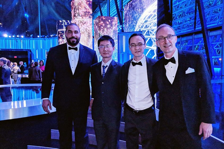 Attending the Breakthrough Prize ceremony on Dec. 3 was, from left, mathematics doctoral student and retired NFL player John Urschel, who was a presenter at the ceremony; New Horizons in Mathematics Breakthrough Prize winners Zhiwei Yun, a Yale math professor who will be joining MIT in January, and new MIT professor of mathematics Wei Zhang; and Mathematics Interim Department Head Michel Goemans.