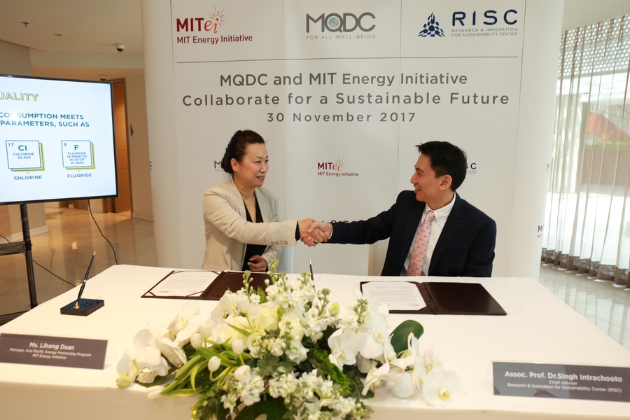 Lihong "Wendy" Duan, manager of the Asia Pacific Energy Partnership Program at the MIT Energy Initiative, and Singh Intrachooto, chief advisor of MQDC’s Research and Innovation for Sustainability Center, shake hands during a signing ceremony to launch the MITEI-MQDC collaboration.