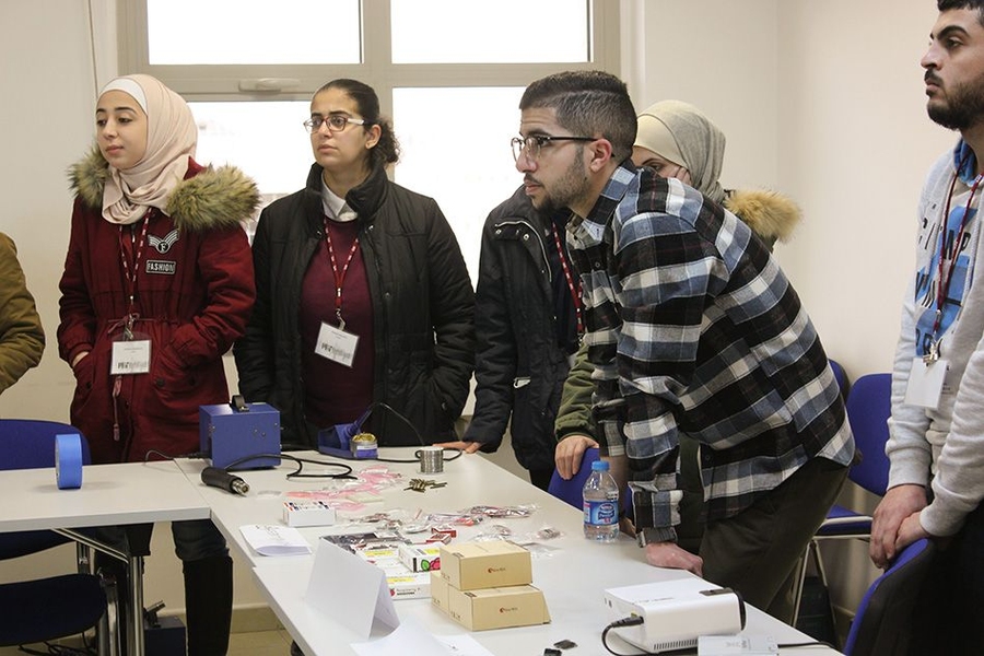 Students listen attentively as their year-long series of classes begins.
