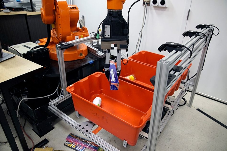 The “pick-and-place” system consists of a standard industrial robotic arm that the researchers outfitted with a custom gripper and suction cup. They developed an “object-agnostic” grasping algorithm that enables the robot to assess a bin of random objects and determine the best way to grip or suction onto an item amid the clutter, without having to know anything about the object before pic...