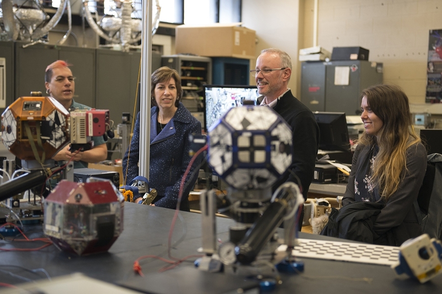 Left to right: MIT Space Systems Lab Director Alvar Saenz-Otero, NASA Johnson Space Center director Ellen Ochoa, MIT Professor David Miller, and incoming graduate student Cody Paige discuss SPHERES, self-propelled microsatellites developed by MIT students. SPHERES have been used on the International Space Station for NASA research since 2006. 