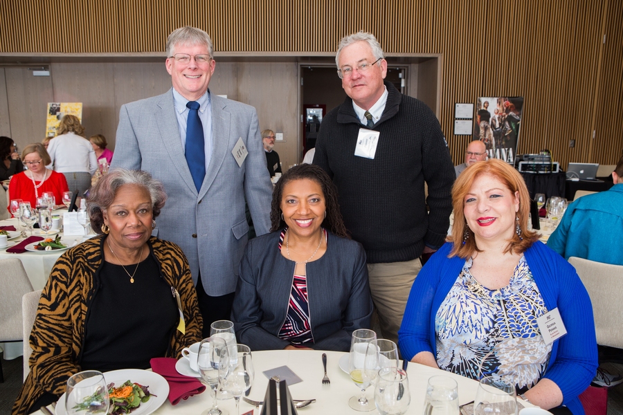New members Dennis Collins of the Department of Housing (standing, left) and Francis Charles of DAPER Intercollegiate Sports (standing, right)) join QCC President Yvonne Gittens, Vice President for Human Resources Lorraine Goffe, and 2018 inductee Professor Georgia Perakis of the MIT Sloan School of Management. 
