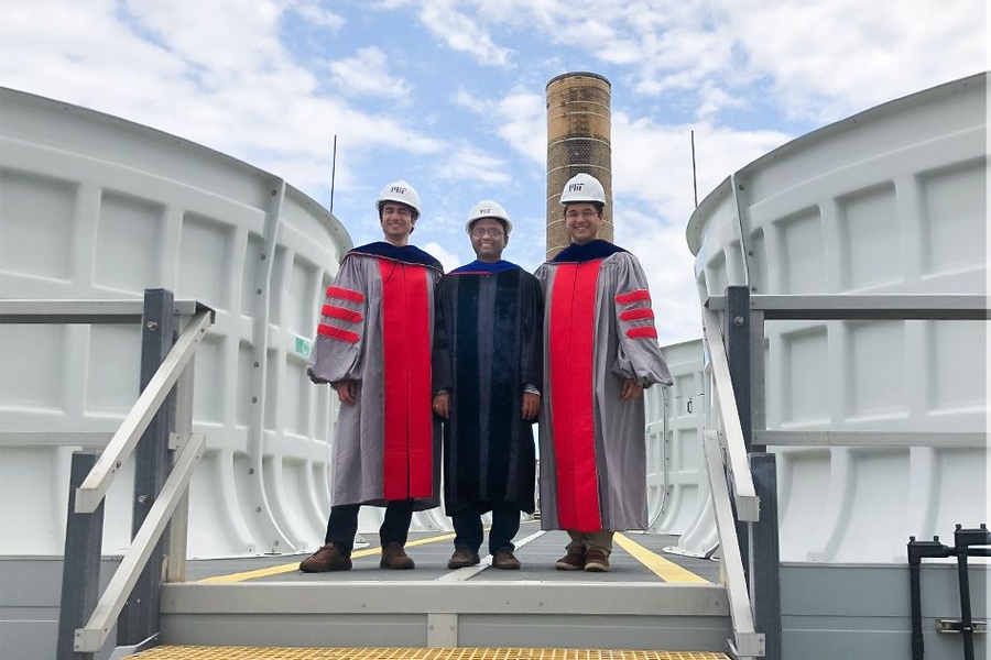 Kripa Varanasi, associate professor of mechanical engineering, poses on the roof of the Central Utility Plant with the two doctoral students who led the research project, Maher Damak (left) and Karim Khalil (right), just after receiving their doctoral hoods this week.