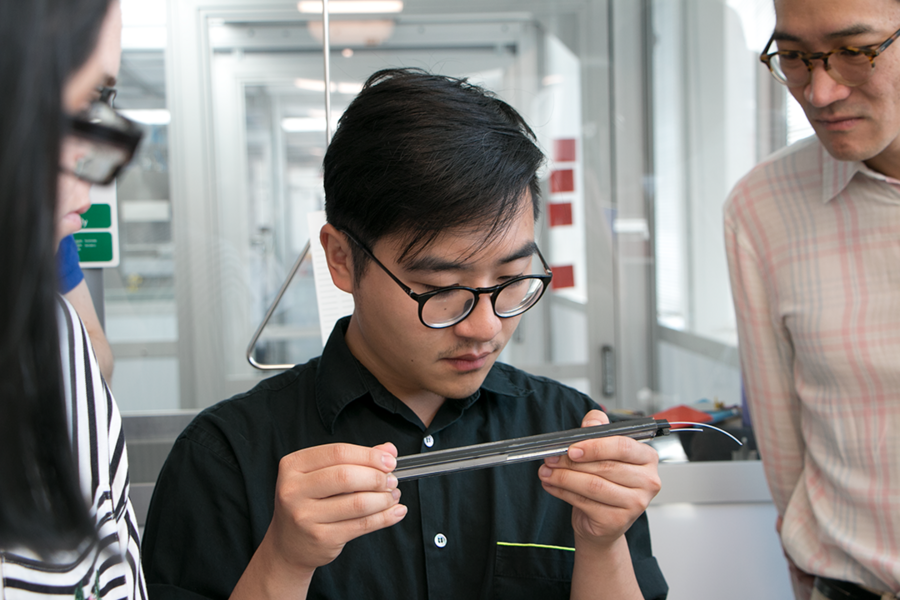 Calvin Zhong '18, who double majored in architecture and comparative media studies at MIT, examines a preform during a tour of AFFOA’s 12 Emily St. headquarters in Cambridge, Massachusetts. Zhong was one of six participants in a two-week Workshop in Advanced Functional Fabrics, held for the first week at MIT and the second week at FIT. 