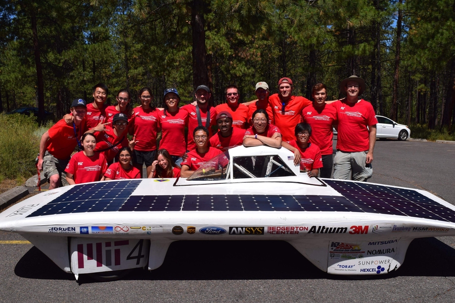 The MIT Solar Electric Vehicle Team poses with their solar vehicle.