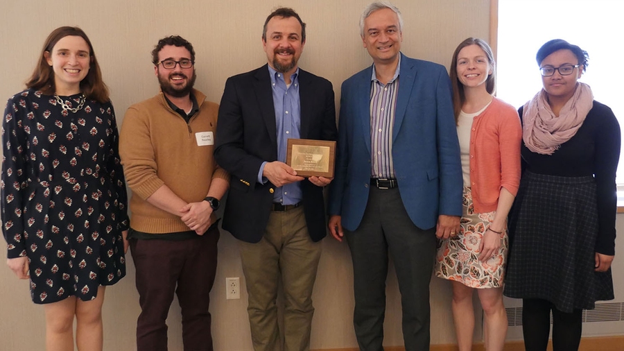 Justin Reich, executive director of the MIT Teaching Systems Lab (holding plaque), was selected for his work on 11.154x (Launching Innovation in Schools).