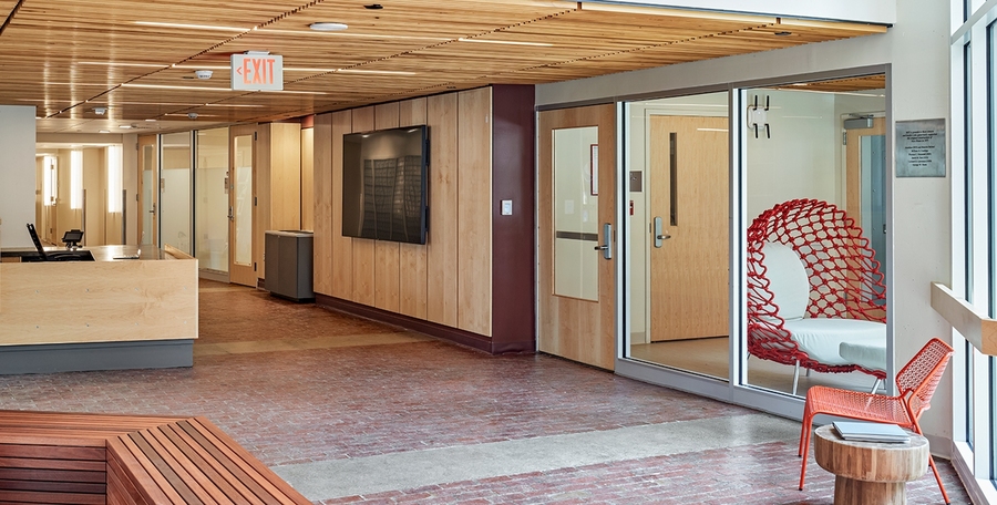 Community spaces accessible from the first-floor arcade level include a house lounge, game room, community-shared country kitchen, expanded makerspace, multi-purpose room, laundry room, fitness room, and music room.