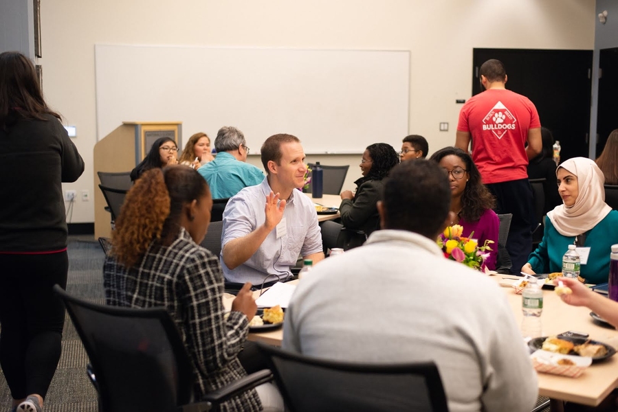 Chemical engineering professor Will Tisdale (center) discusses research with ACCESS attendees during lunch.