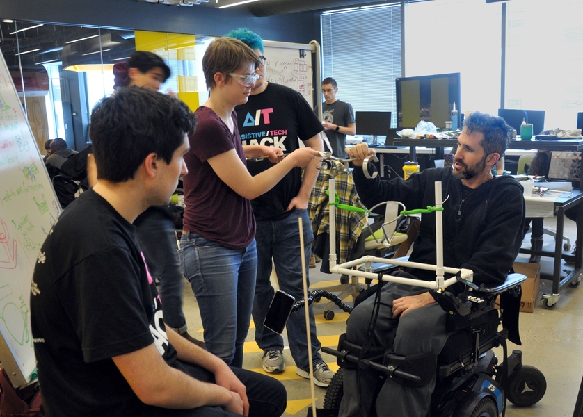 Alex Rosenberg (seated) works with his team to create a technology to play catch with his sons. 