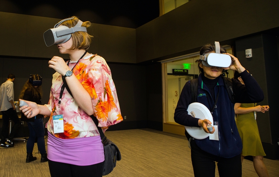 Visitors wear virtual reality headsets in the MIT.nano Immersion Lab.  