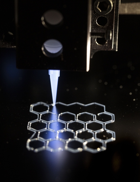 Associate Professor Xuanhe Zhao and PhD candidate Hyunwoo Yuk use 3-D printing technologies to create complex 3-D structures. Here, a polymer scaffold ink is being printed on a silicon wafer to provide structural support for other ink materials with poorer printability during the 3-D printing process. This scaffold ink can be washed away after printing, leaving a complex 3-D structure made of hard...