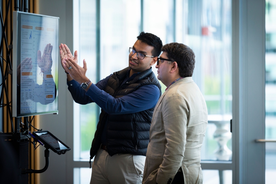Senior Anagh Tiwary discusses his capstone project with JR East Professor Ali Jadbabaie during the digital poster presentation session. 