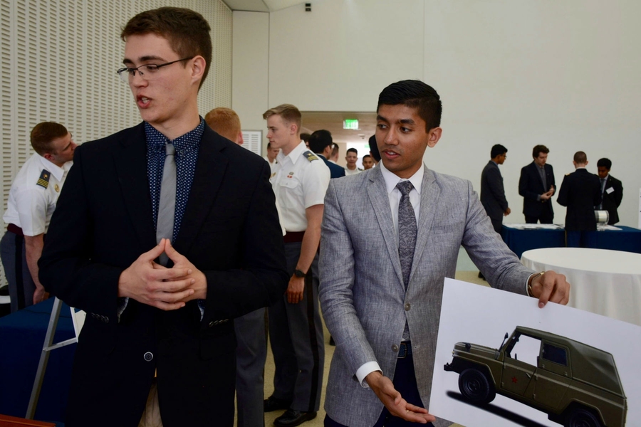 Machine Intelligence Community members and ROTC students Ian Miller and Rishi Shah present a portable computer vision system they built to help soldiers detect cars and people in their field of view. 
