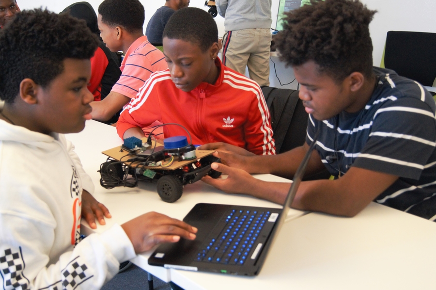 Because there were only four race cars available, students worked in teams to write the code for their cars.