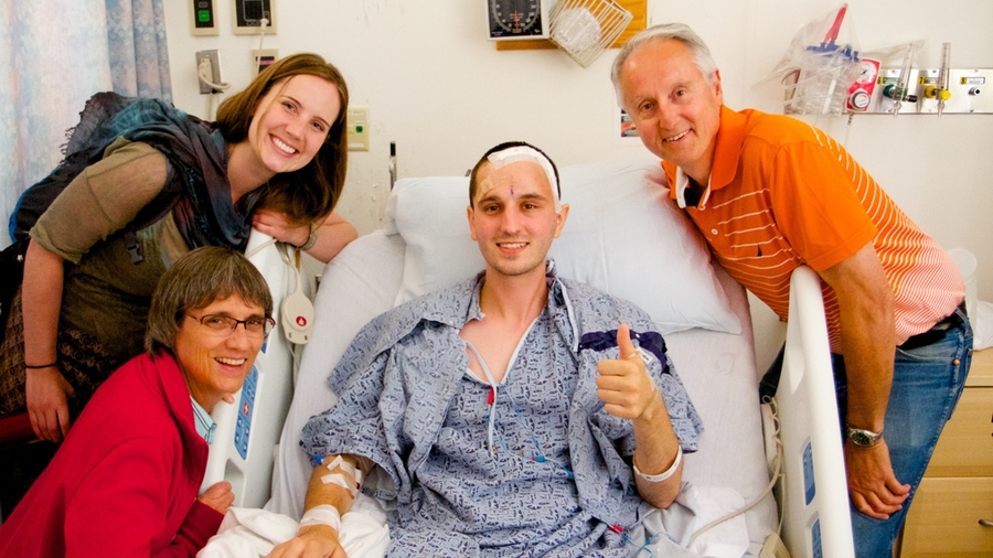 Keating rests after the completion of his 10-hour surgery at Brigham and Women’s Hospital, alongside his mother, Lynn; father, John; and sister, Laura. 
