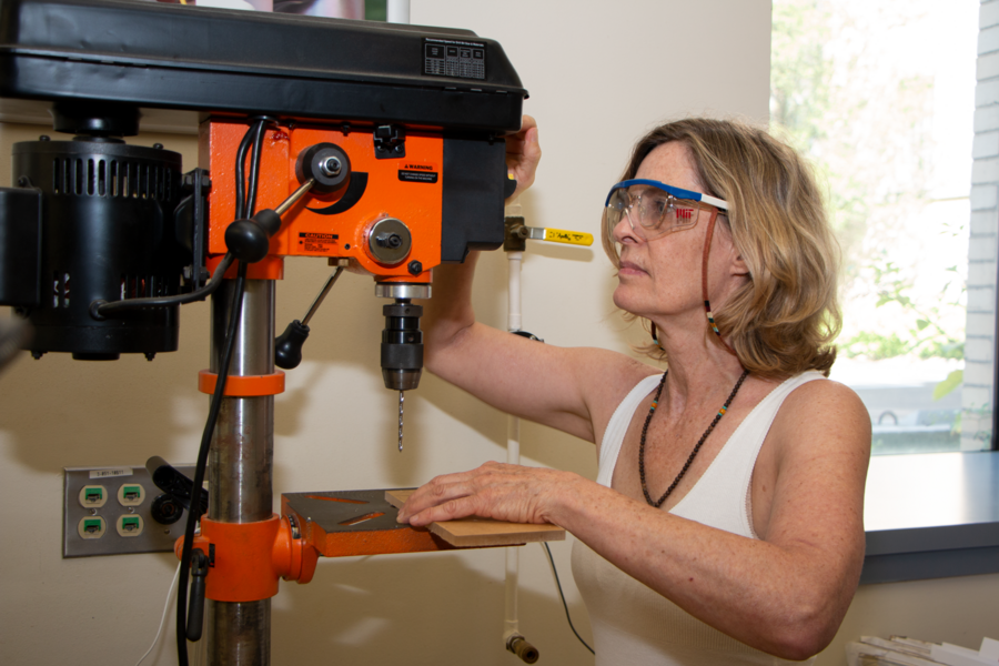 Susan Haverstick, a Natick High School biology and engineering teacher, operates a drill press in the Pappalardo Lab at MIT during the MRL MRSEC’s summer Science Teacher Enrichment Program. 