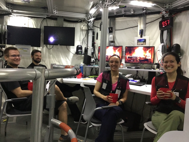 The crew of a simulated Mars mission enjoys some brief R&R with coffee by the (virtual) fire. Left to right: Christian Clark, Barret Schlegelmilch, Ana Mosquera, and Julie Mason. 