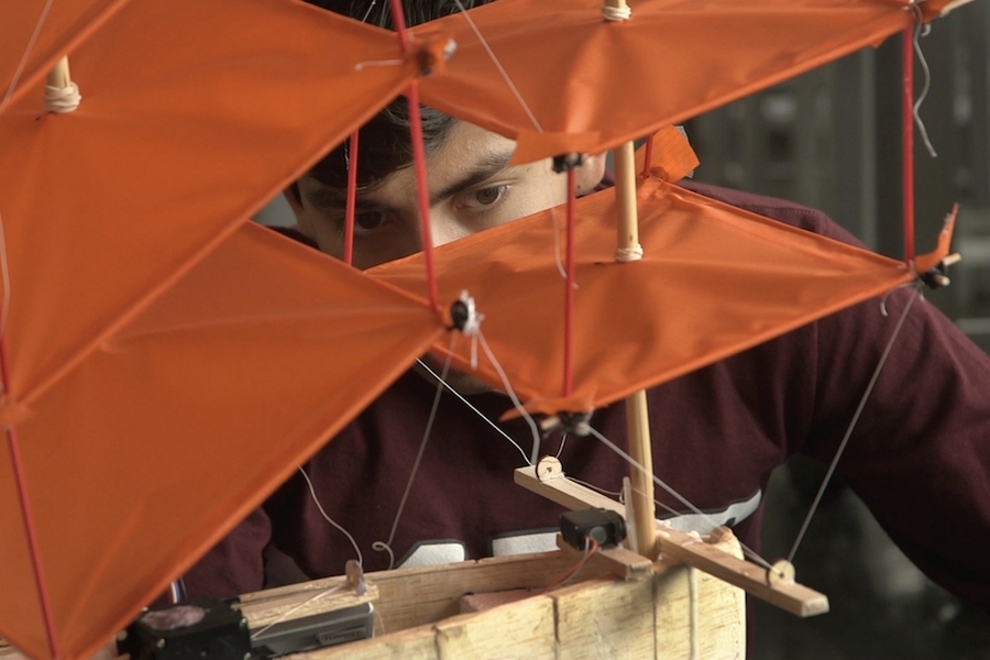 Rodrigo Vasquez examines his team's final project, a plane that also acts a boat on water.