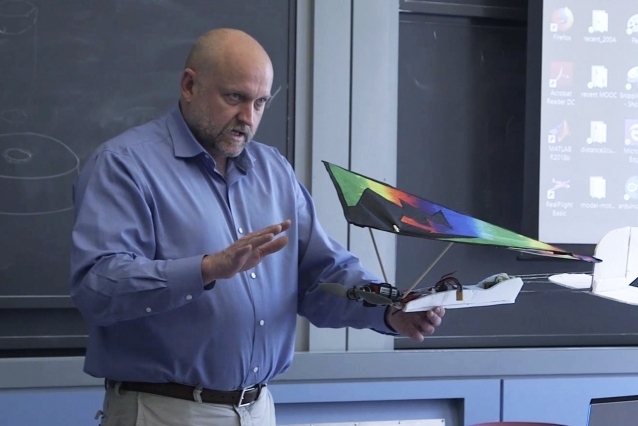 Daniel Frey, professor of mechanical engineering, shows students in class 2.00a a self-designed plane he built from a kite and some foam core.