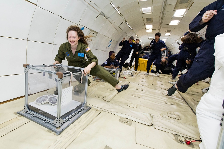 Ariel Ekblaw, founder and lead of the Space Exploration Initiative, tests the latest iteration of her TESSERAE self-assembling architecture onboard a parabolic research flight.