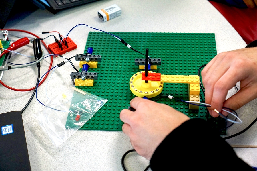 In 8.02 (Electricity and Magnetism) experiments, students use common, playful materials such as Lego sets, encouraging them to have a maker mindset and bring rigorous mathematics to life.  