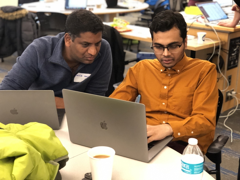 Chekuri Choudary (left), an infrastructure specialist with IBM Cognitive Systems Lab Services, works with MIT graduate student Ravichandra Addanki.
