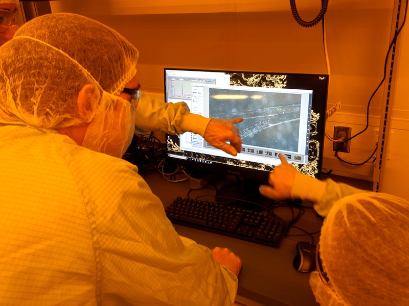 During the testing of their microfluidic devices, students utilized the new fluidic test station at MIT.nano to investigate how small microparticles behave when a channel splits at a junction.