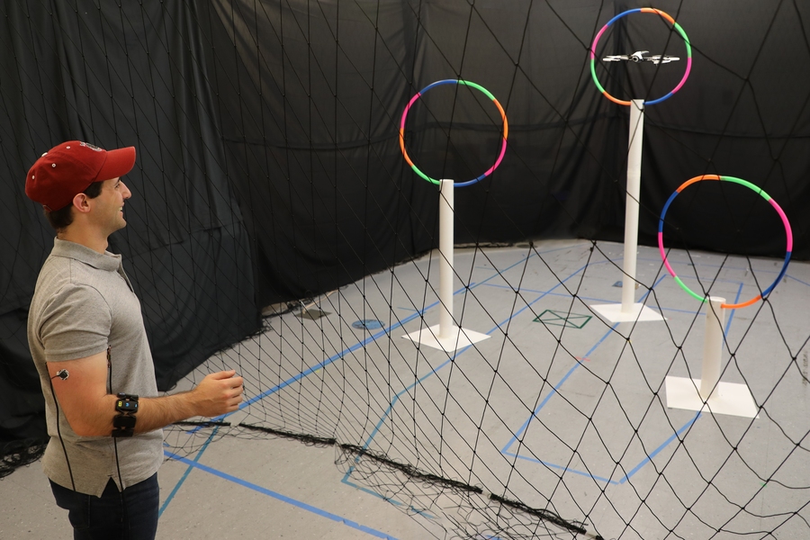 Lead author Joseph DelPreto controls a "Conduct-A-Bot" drone with his arm muscles.