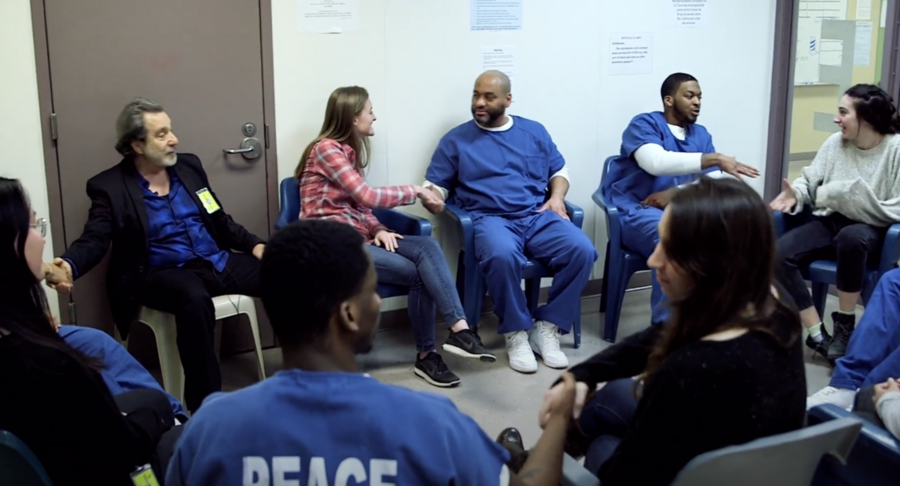 Students shake hands at the end of a class as part of the MIT Prison Education Program. A documentary film about the program has won a New England Emmy Award.