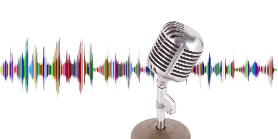 Photo of a radio-style microphone in front of a multicolor illustration of a sound wave
