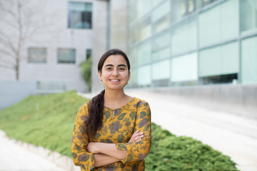 Photo of Gurrein Madan posing with arms crossed outside of an MIT research building