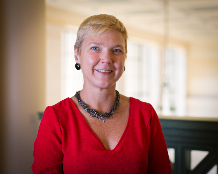 Portrait photo of Linda Griffith with a background of MIT's Lobby 10