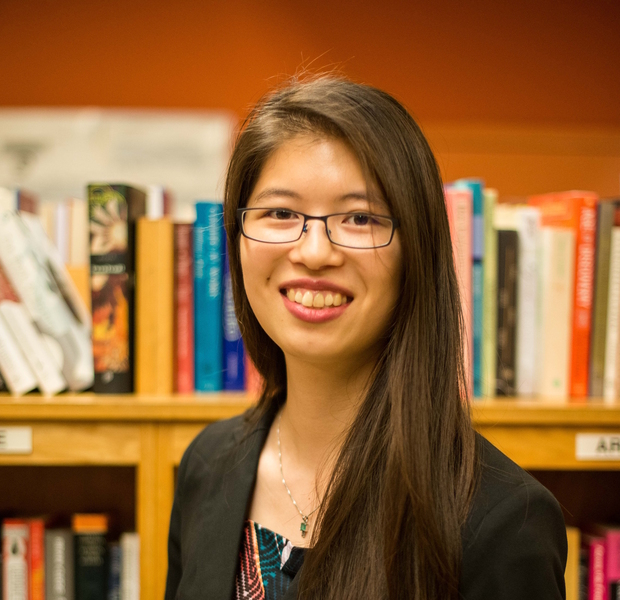 Portrait photo of Cathy Wu with a bookshelf in the background